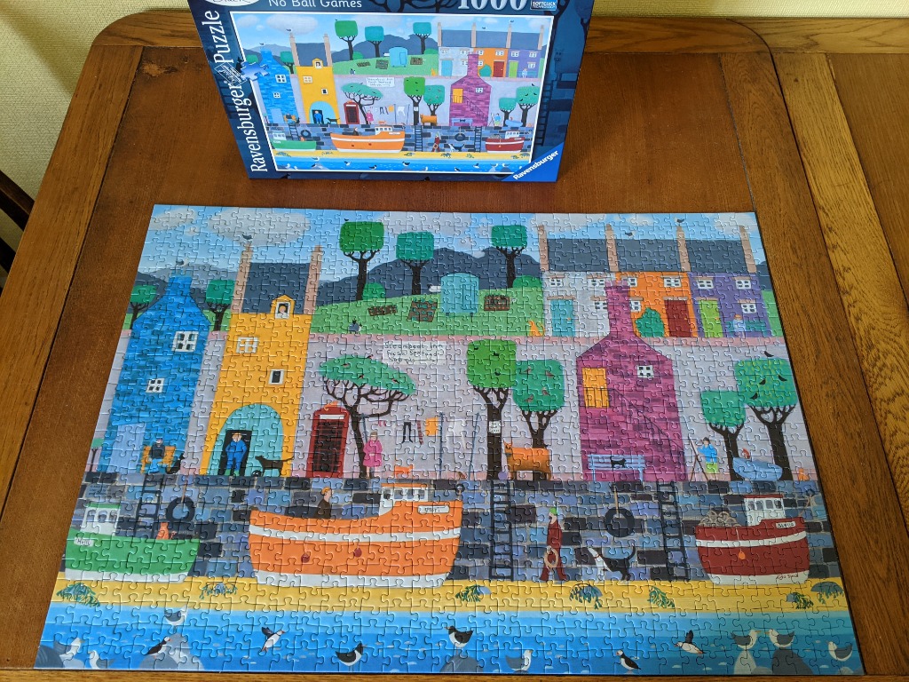 An illustration of a colorful harbor scene with houses, boats, and seagulls.
