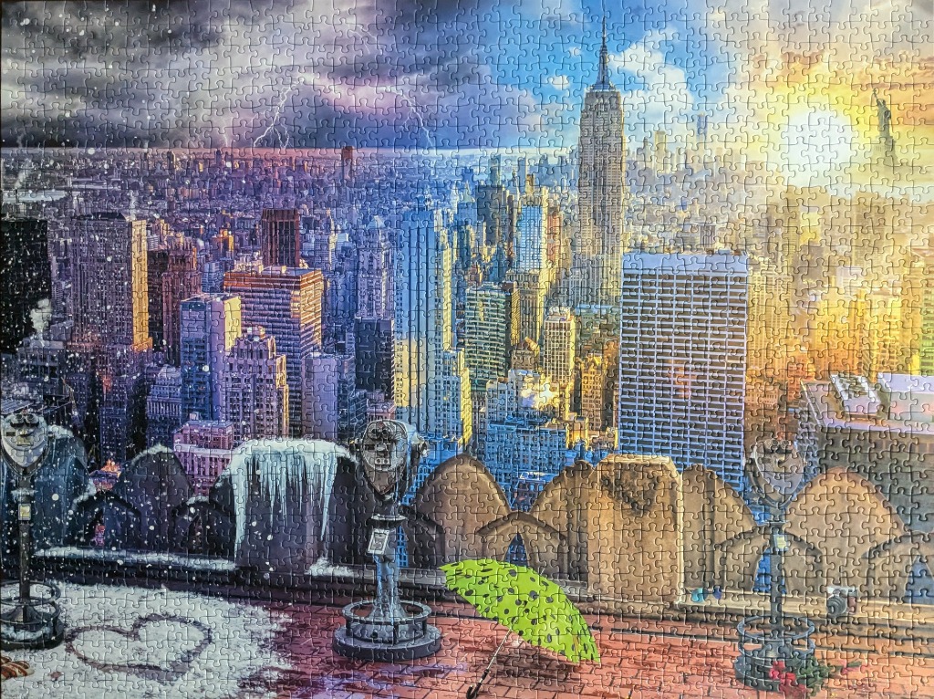 A split-view illustration of the New York City skyline transitioning from a stormy, snowy night to a sunny, warm day.