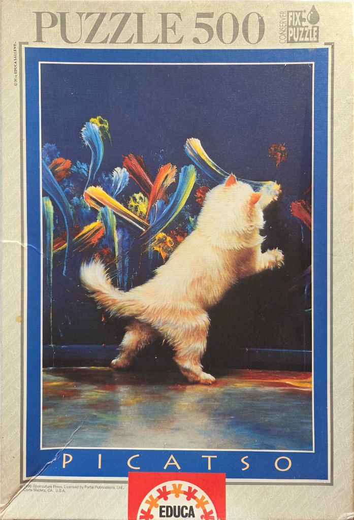 A fluffy white cat standing on its hind legs and pawing at a dark wall painted with colorful abstract brushstrokes.