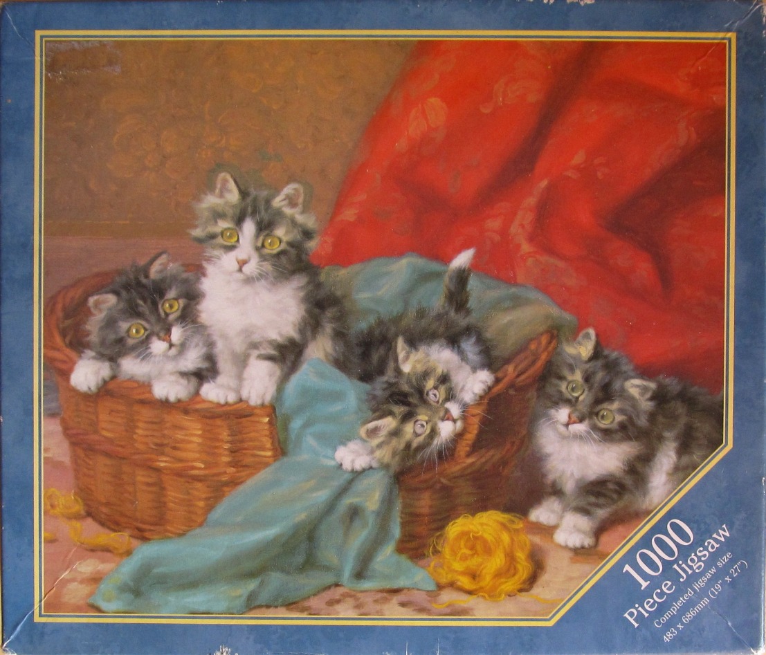 Four fluffy grey and white kittens in and around a wicker basket with yarn.