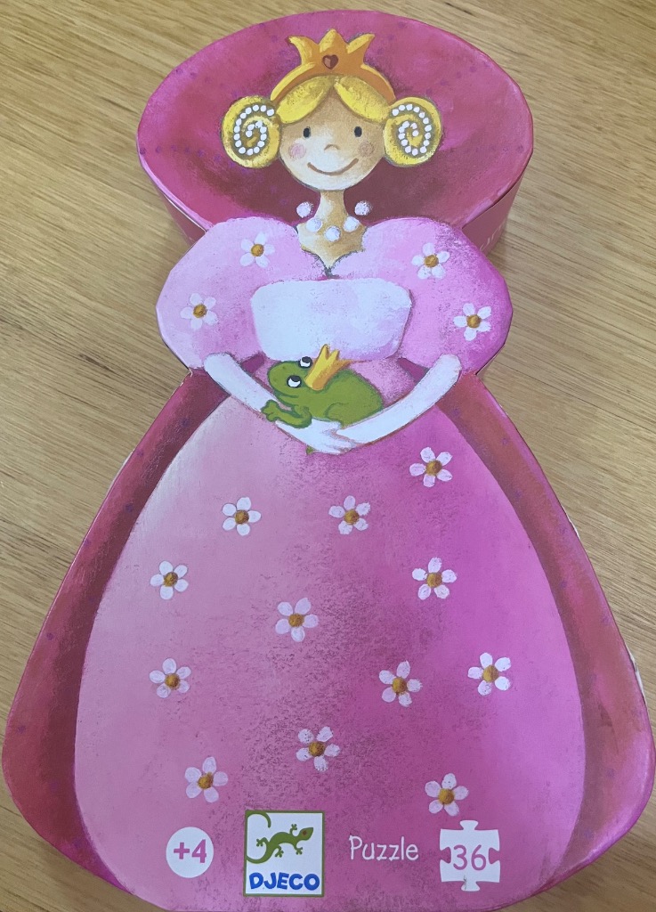 A whimsical illustration of a smiling princess in a pink floral dress holding a frog wearing a crown.