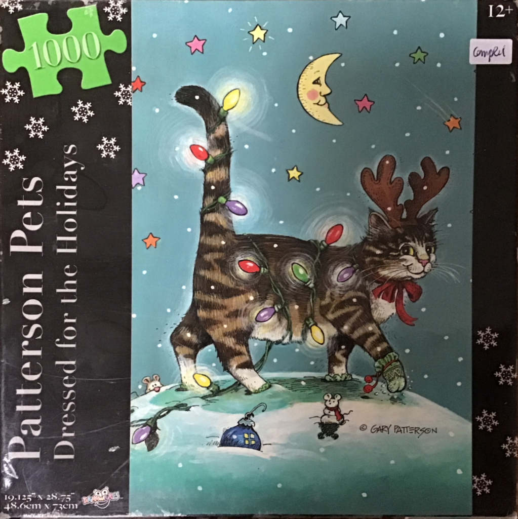 A cartoon tabby cat tangled in Christmas lights, wearing reindeer antlers, stands in the snow at night.