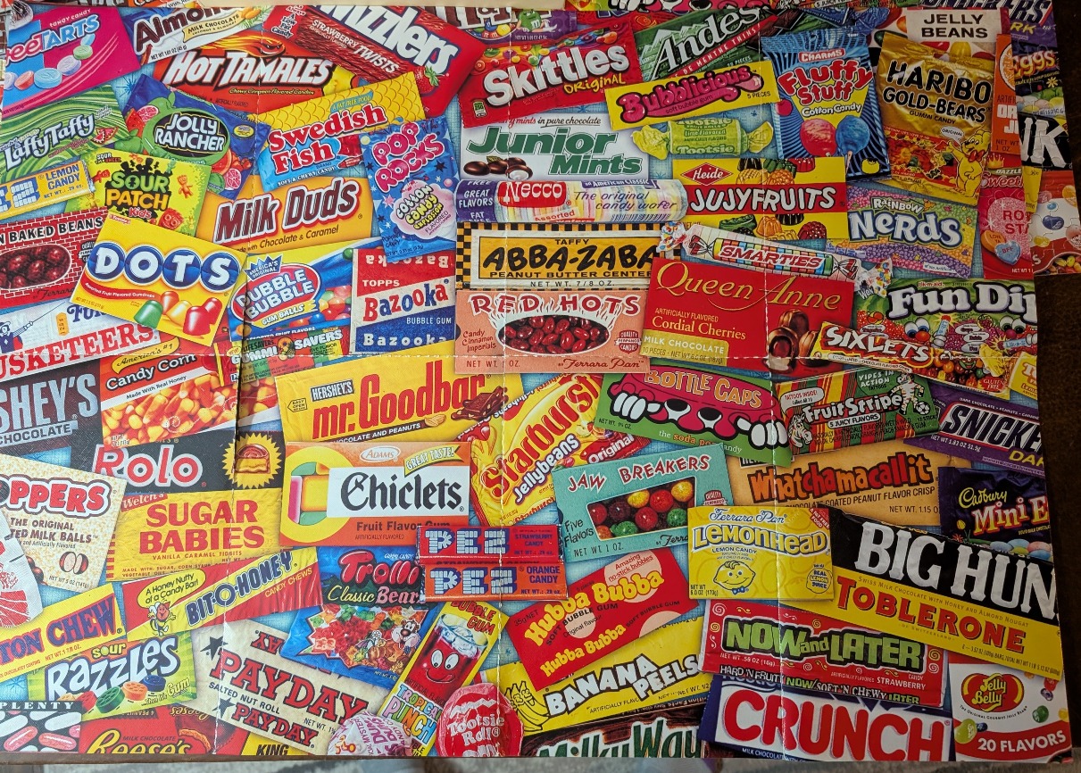 A dense, colorful collage of iconic vintage candy wrappers and boxes arranged in a tiled pattern.