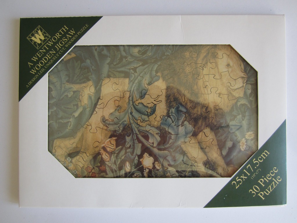 A male lion depicted in the style of a William Morris tapestry surrounded by dense, leafy foliage and flowers.
