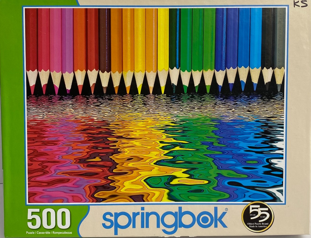 A row of sharpened colored pencils reflected in rippling water, showing a full spectrum of colors.