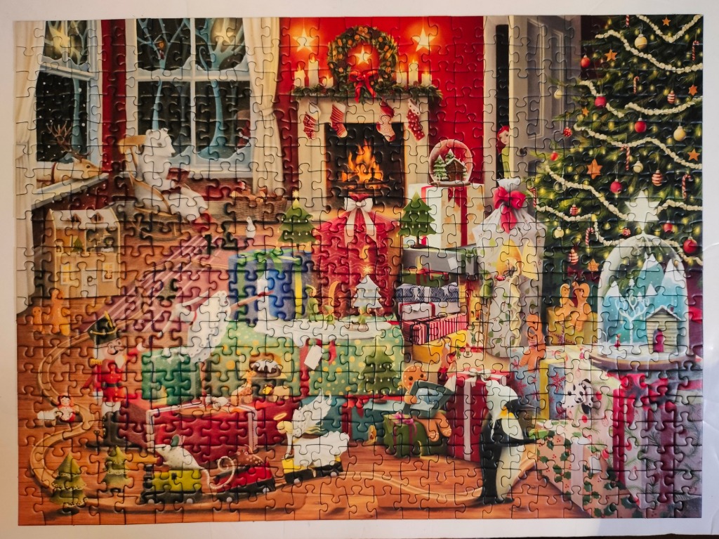 Cozy indoor Christmas scene featuring a fireplace, decorated tree, and pile of wrapped gifts.