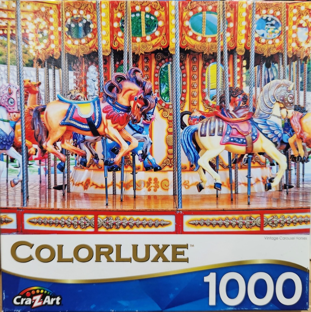 A close-up view of vintage carousel horses painted in vibrant colors, standing on a rotating wooden platform.