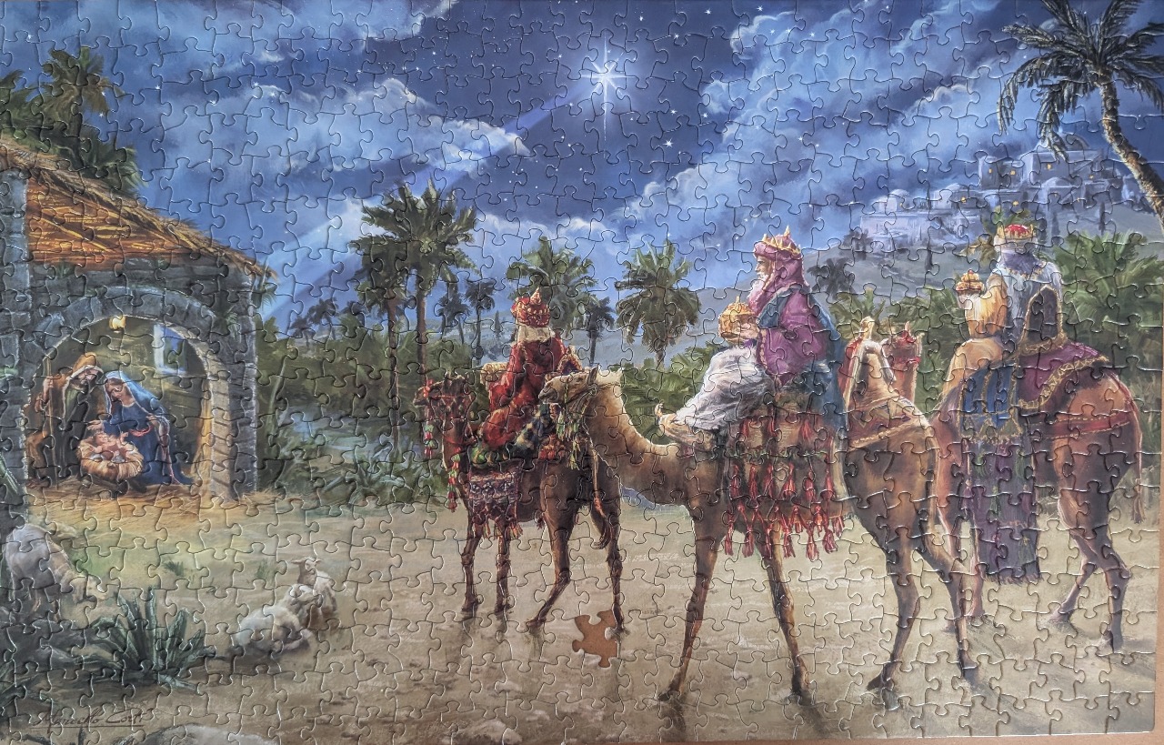 Painting of the biblical nativity scene with the three wise men arriving on camels under a bright star.