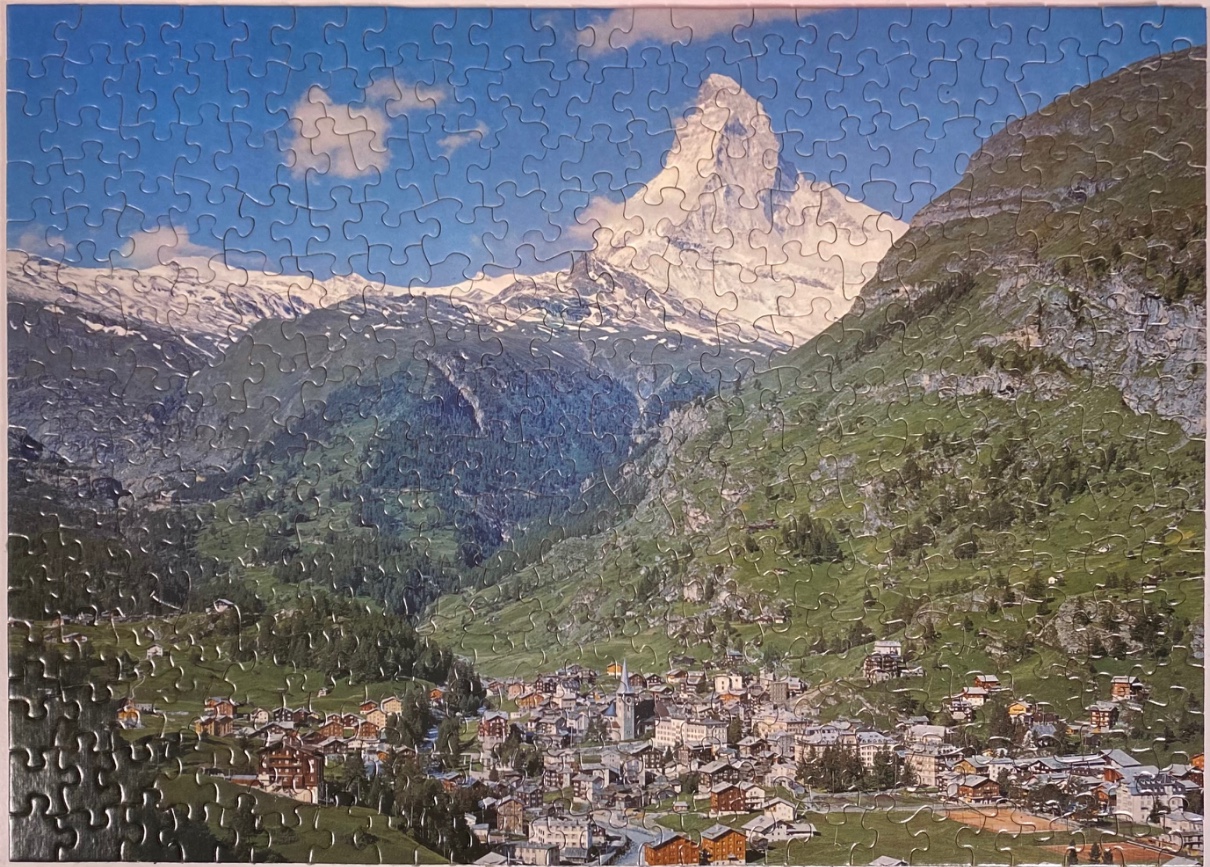 A panoramic landscape photo of Zermatt, Switzerland, with the Matterhorn mountain towering in the background.
