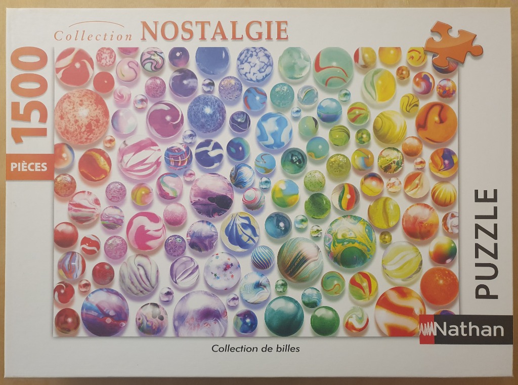A collection of assorted colorful glass marbles scattered against a white background.