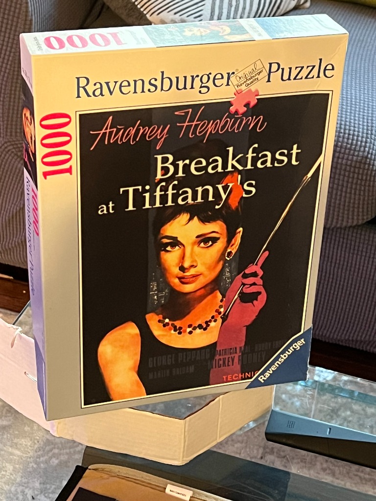 Breakfast at Tiffany's poster featuring Audrey Hepburn with a pink cigarette holder.