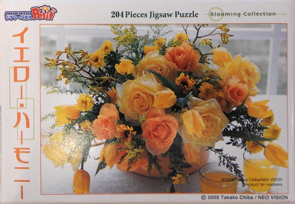 A lush floral arrangement of yellow and peach-colored roses and tulips in a ceramic bowl.