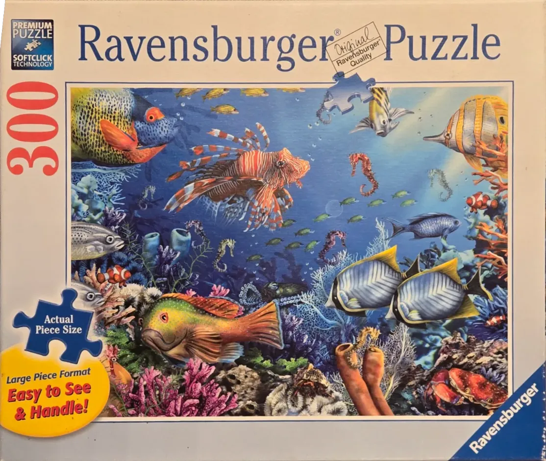 Vibrant underwater coral reef scene teeming with various tropical fish and marine life.
