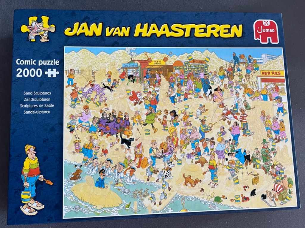 A crowded comic illustration of a bustling beach filled with people creating intricate sand sculptures.