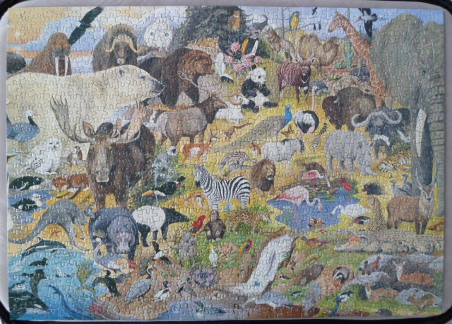 A dense illustration of dozens of diverse wild animals from various habitats gathered together in a single landscape.