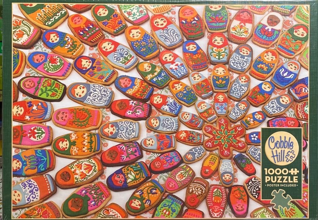 A collection of colorful Russian nesting doll-shaped cookies arranged in a spiral pattern.
