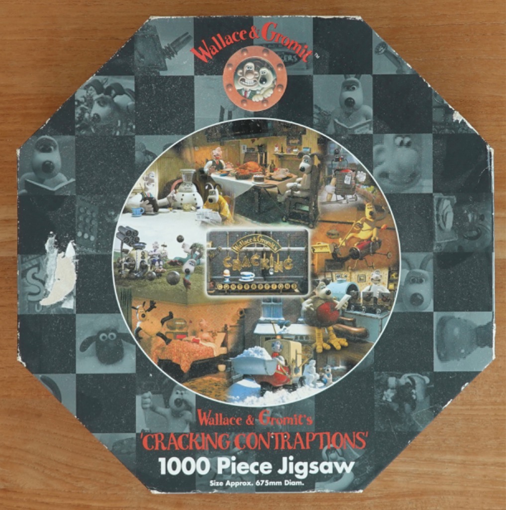 Collage of Wallace and Gromit scenes in a circular frame against a dark checkerboard background.