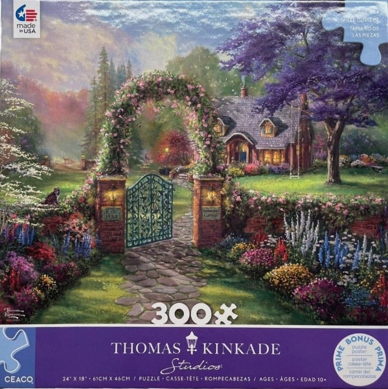 An idyllic countryside cottage with a flower-covered garden gate at sunset.
