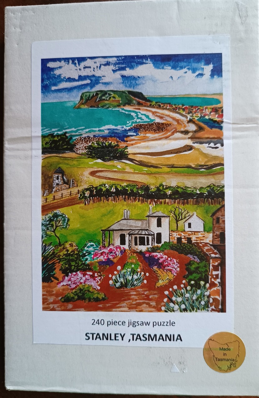 Watercolor painting of a coastal landscape in Stanley, Tasmania, featuring a prominent headland and a foreground garden.