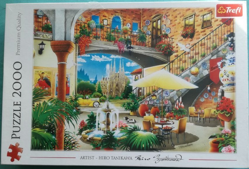 A sunny Mediterranean-style courtyard scene featuring a fountain, outdoor dining, and the Sagrada Familia in the distance.