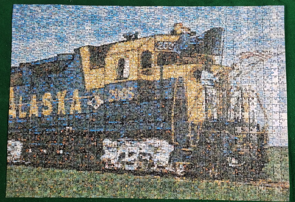 An impressionistic-style painting of an Alaska Railroad train engine against a blue sky.