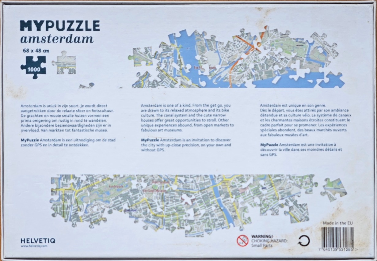 An aerial map of Amsterdam divided into two horizontal sections of puzzle pieces against a white background.