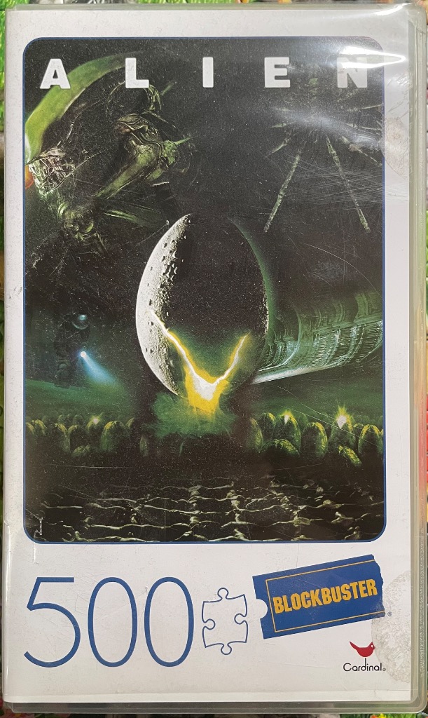 Artwork of a cracked alien egg in a dark, bio-mechanical landscape under the title Alien.