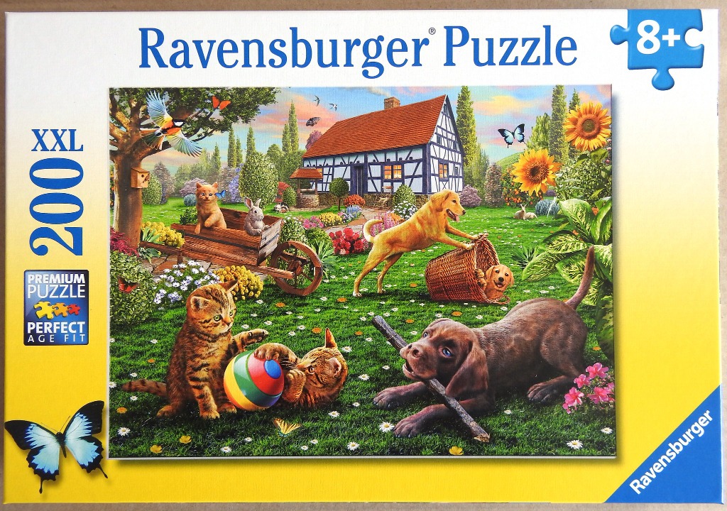 A sunny garden scene with a timber-framed cottage featuring three puppies, two kittens, and various birds and butterflies.