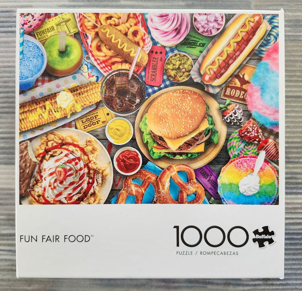 A vibrant assortment of fairground foods including a burger, hot dog, corn on the cob, funnel cake, and shaved ice.