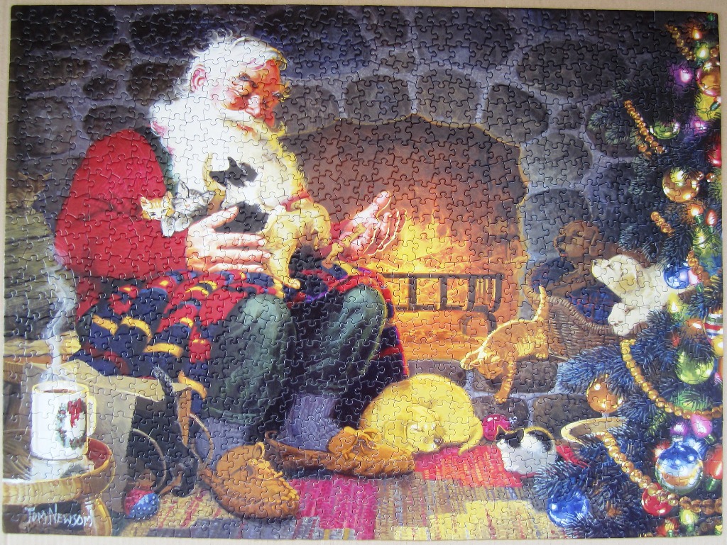 Santa Claus sitting by a fireplace with many cats and a Christmas tree in a warm, cozy room.