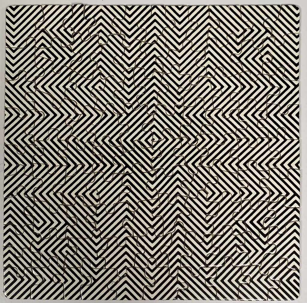 A black and white optical illusion pattern featuring repeating chevron and diamond shapes.
