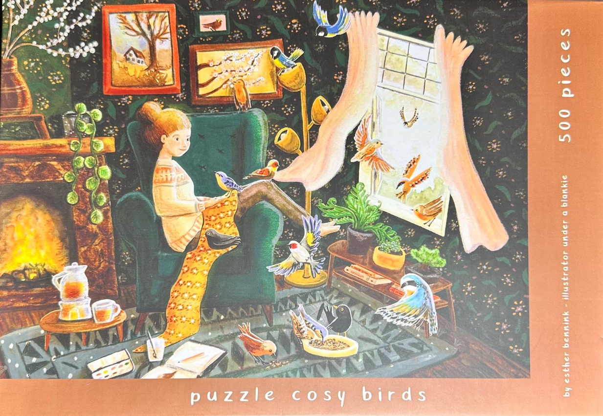 A woman sits in a green armchair knitting with many colorful birds around her in a cozy, decorated room.