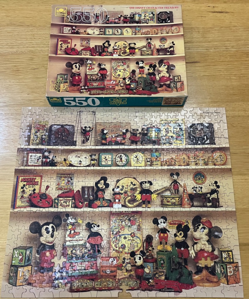 A collection of vintage Disney character toys, figurines, and memorabilia displayed on shelves.