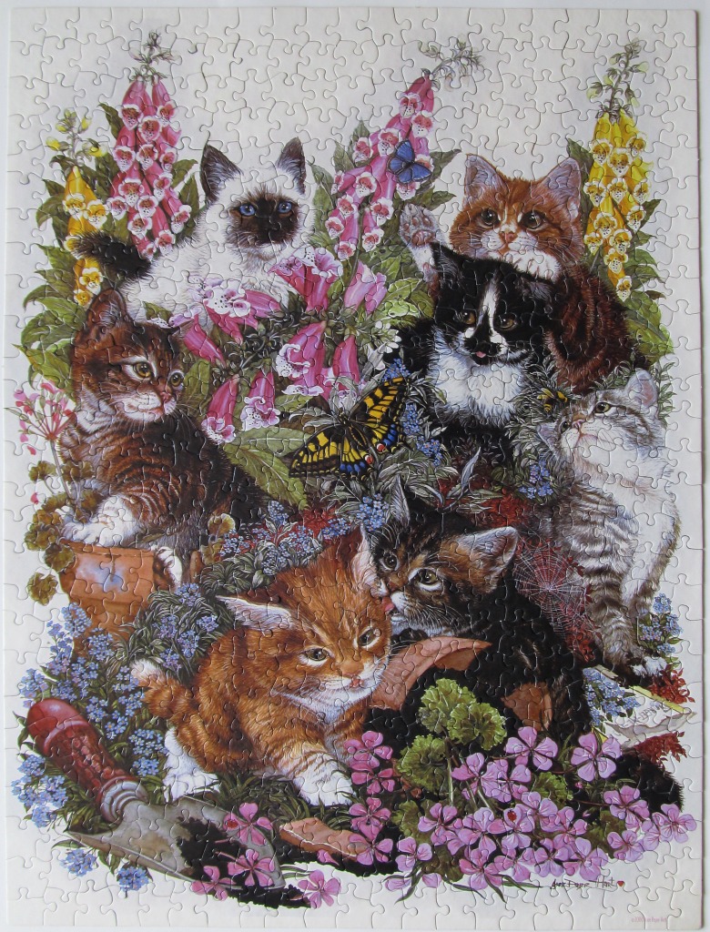 An illustration of several kittens playing amongst garden flowers and a trowel.