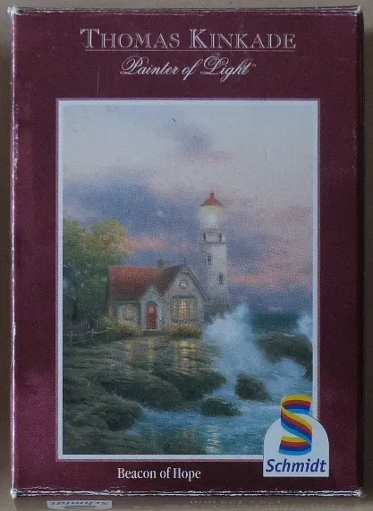 A lighthouse stands beside a small stone cottage on a rocky coastline at twilight.