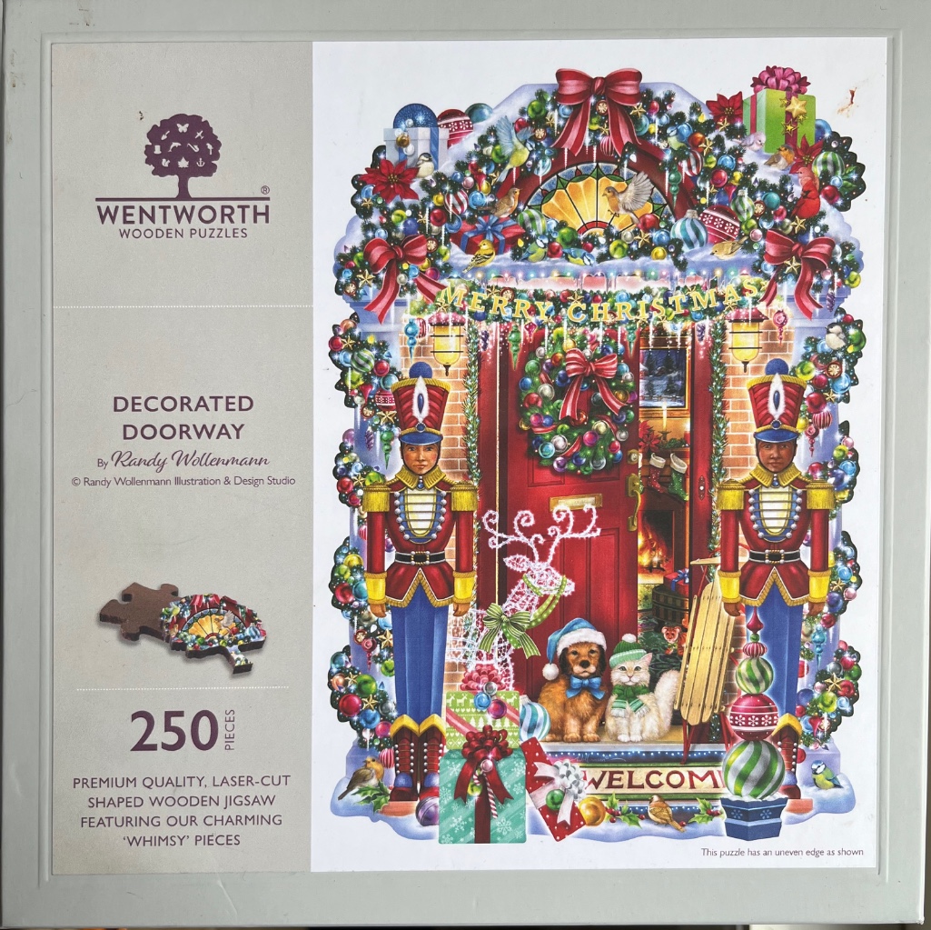 A Christmas scene featuring a doorway decorated with nutcrackers, a wreath, and pets.