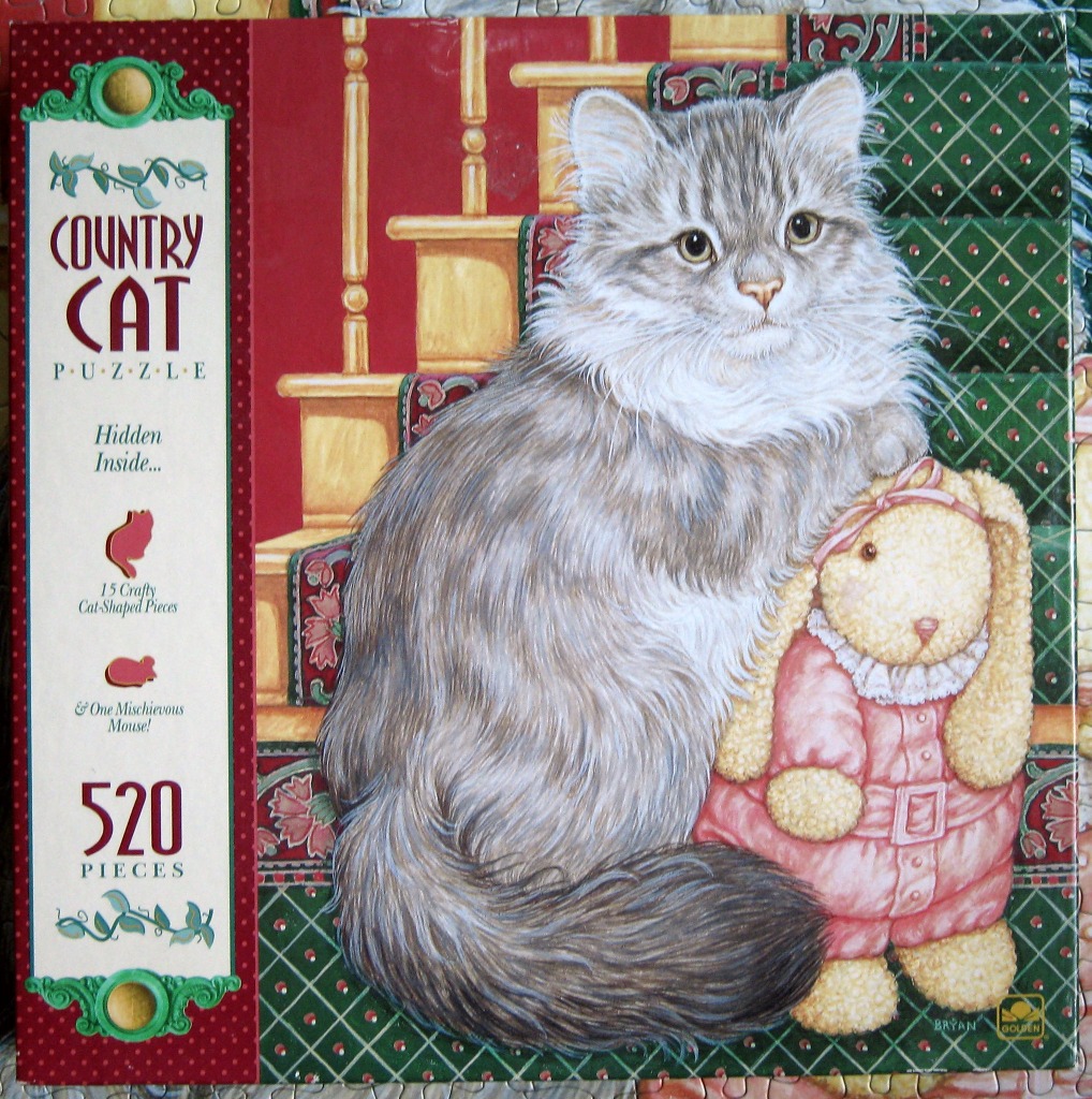 A long-haired grey tabby cat sitting on a carpeted staircase next to a plush toy bunny.