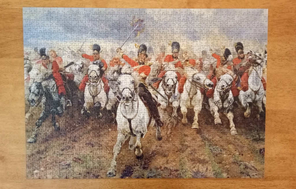 A painting of a charge of British cavalry soldiers on white horses across a muddy battlefield.