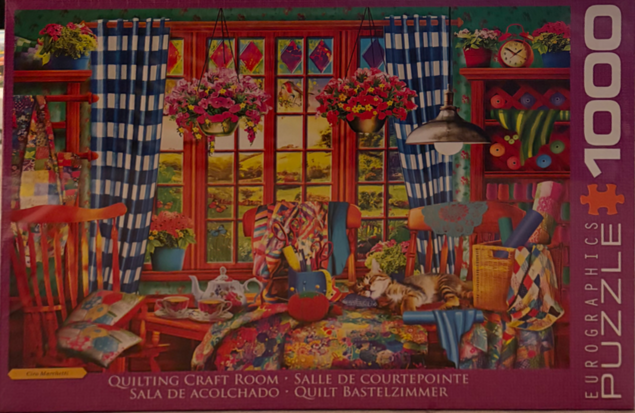 A cozy, vibrant craft room filled with quilting supplies, a sleeping tabby cat, and a view of a sunny garden.