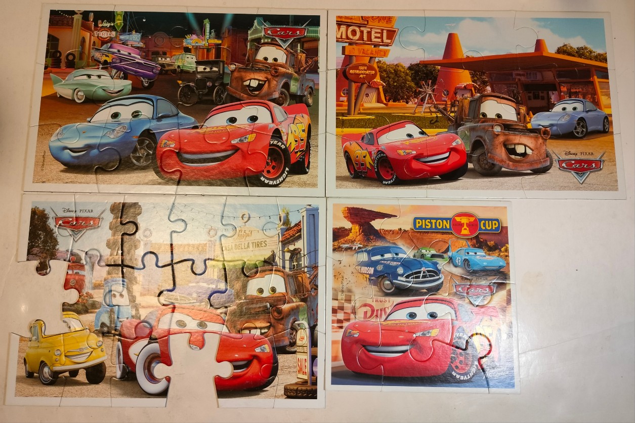 Collage of four animated scenes featuring anthropomorphic race cars and trucks from a popular children