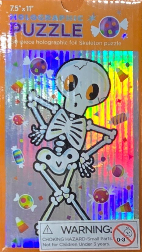 Cartoon skeleton standing with hands on hips surrounded by candy on a holographic foil background.