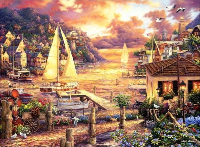 A sunny seaside village with sailboats on the water and stone docks in the foreground at sunset.