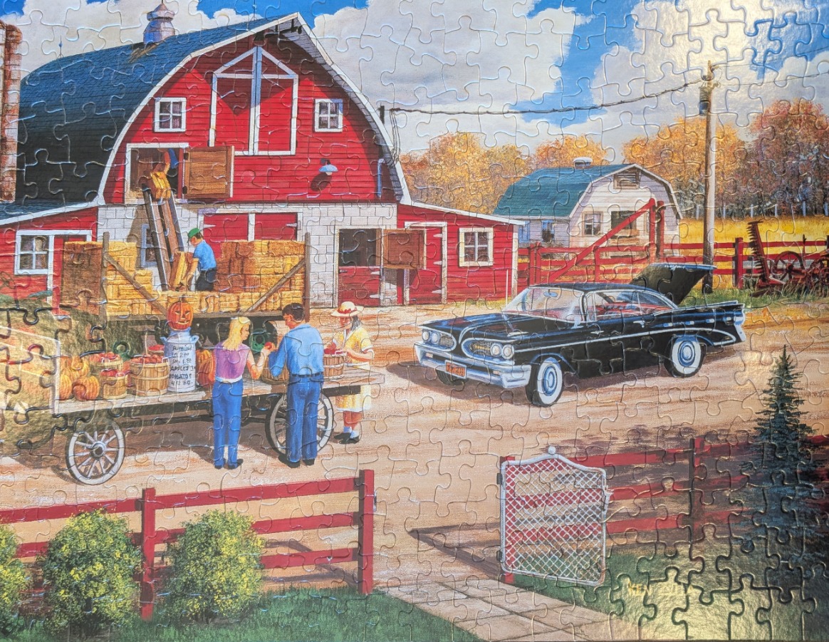 A countryside scene featuring a red barn, a black vintage car, and a farm stand selling pumpkins and produce.