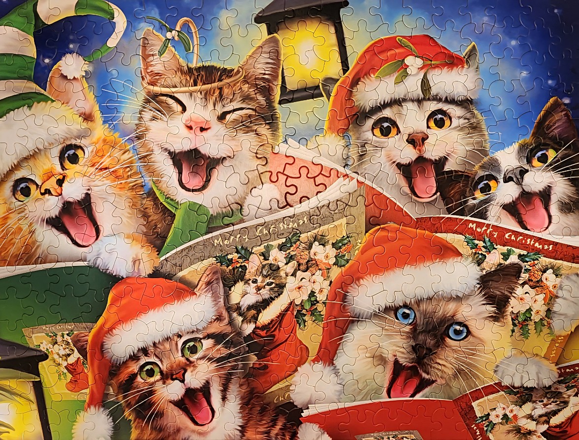 Five cats wearing Christmas hats and scarves, singing together in a joyful holiday illustration.