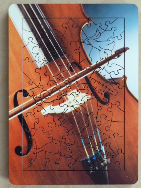 Close-up view of a violin with a bow resting diagonally across the strings.
