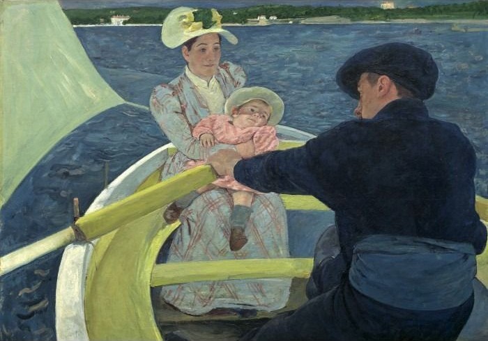 A man rowing a boat carrying a woman holding a small child across dark water.