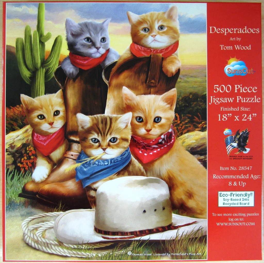 Four kittens wearing colorful bandanas, posing with cowboy boots and a hat in a western desert scene.