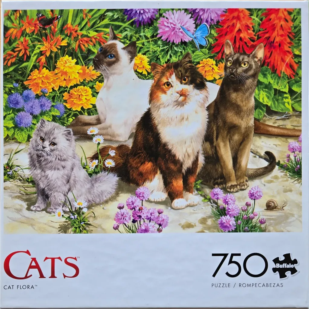 Four cats of various breeds sitting in a vibrant flower garden with butterflies