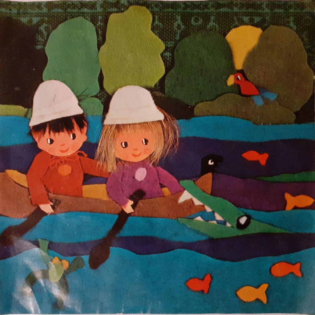 Two children in a canoe encountering a crocodile in a whimsical felt art illustration.