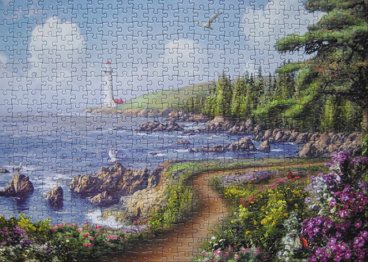 A peaceful coastal landscape featuring a white lighthouse, a winding path through flower gardens, and blue ocean water.